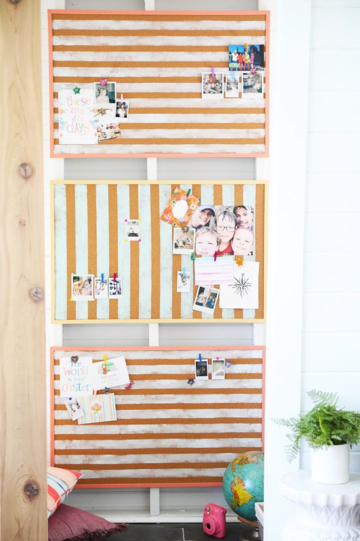 Three photo boards stacked in a row. The top and bottom ones have horizonal orange lines running accross them and the middle one has vertical orange lines running up and down.