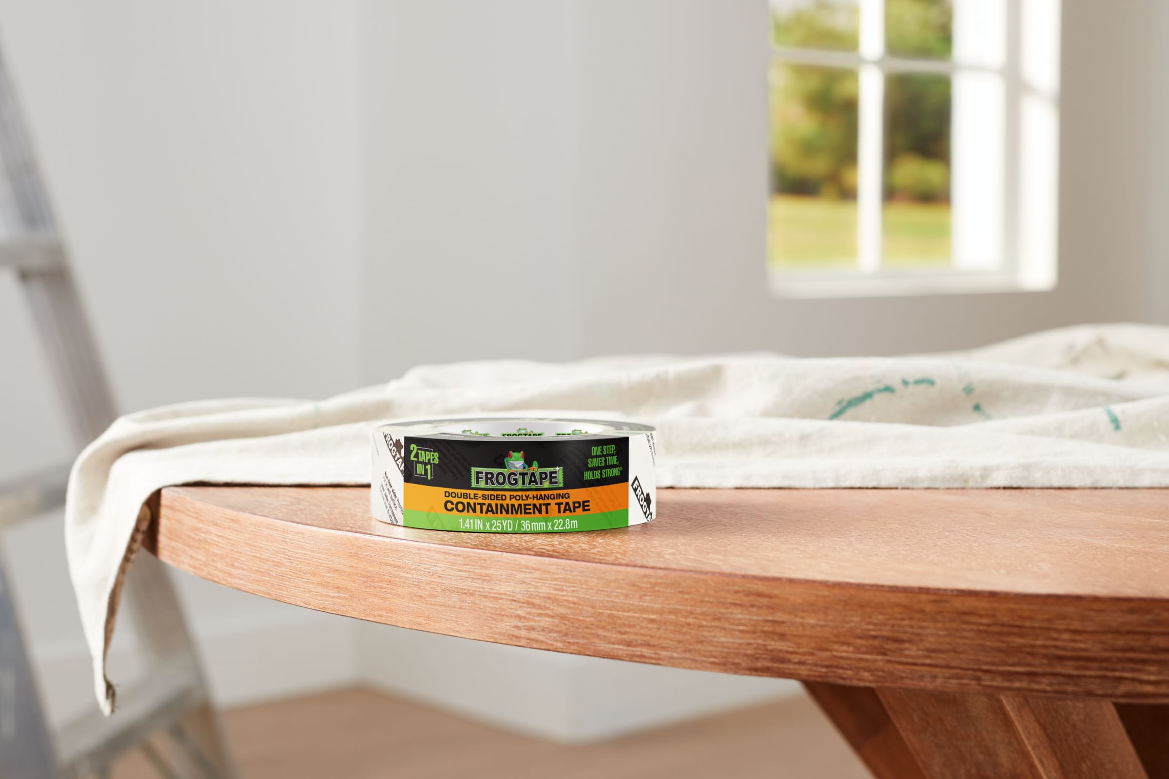 FrogTape Double Sided Poly-Hanging Containment Tape on a round wooden table