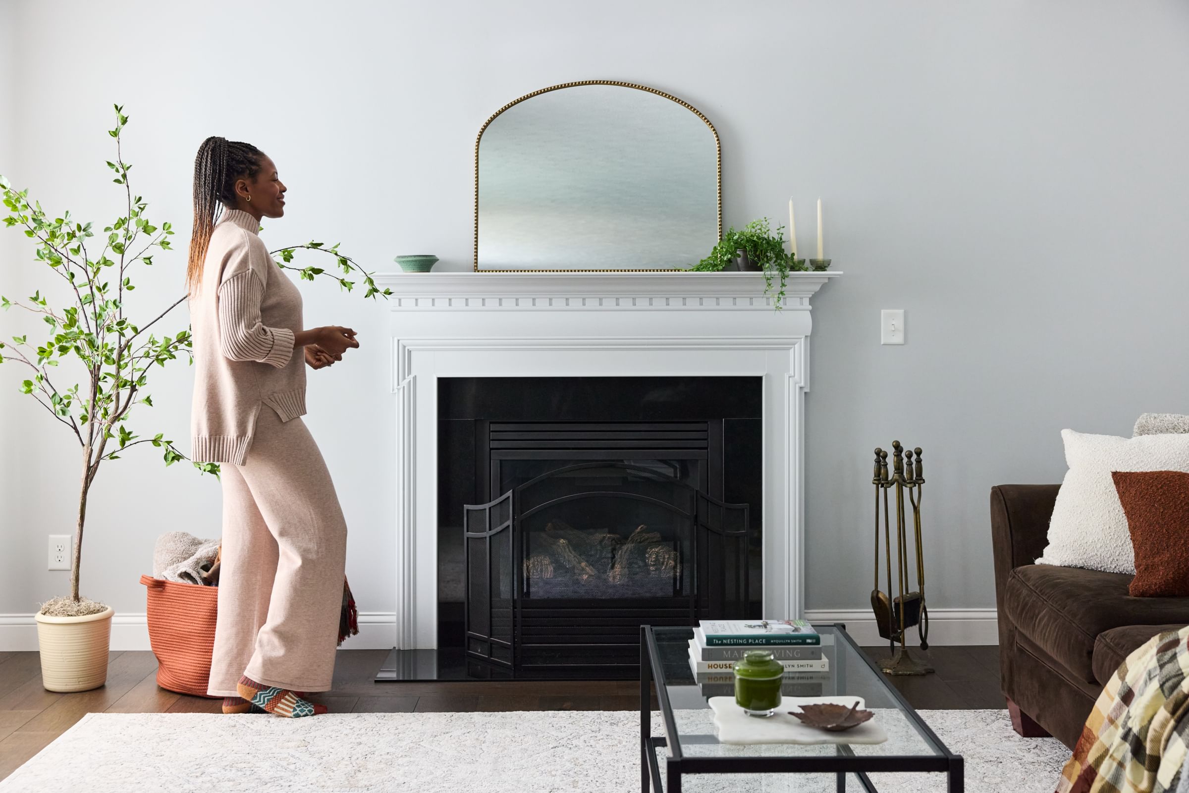 Woman prepping her mantle for Holiday decorating