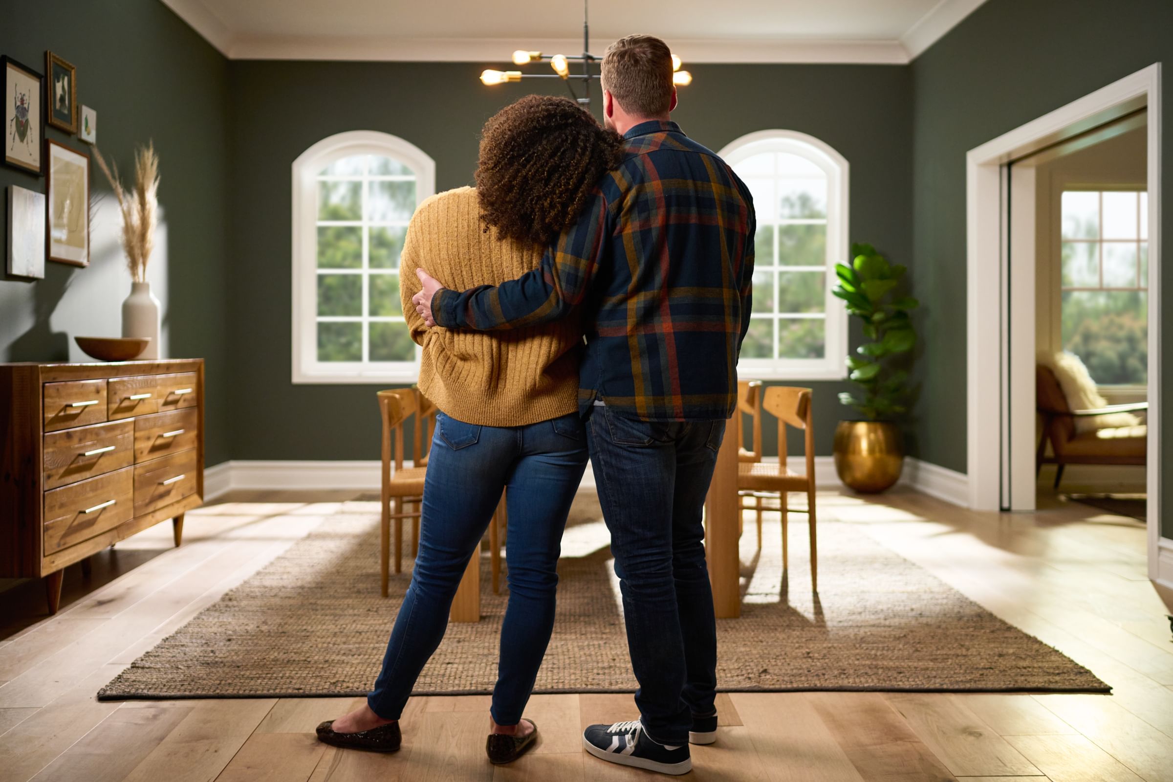 Couple looking at their freshly painted green dining room.