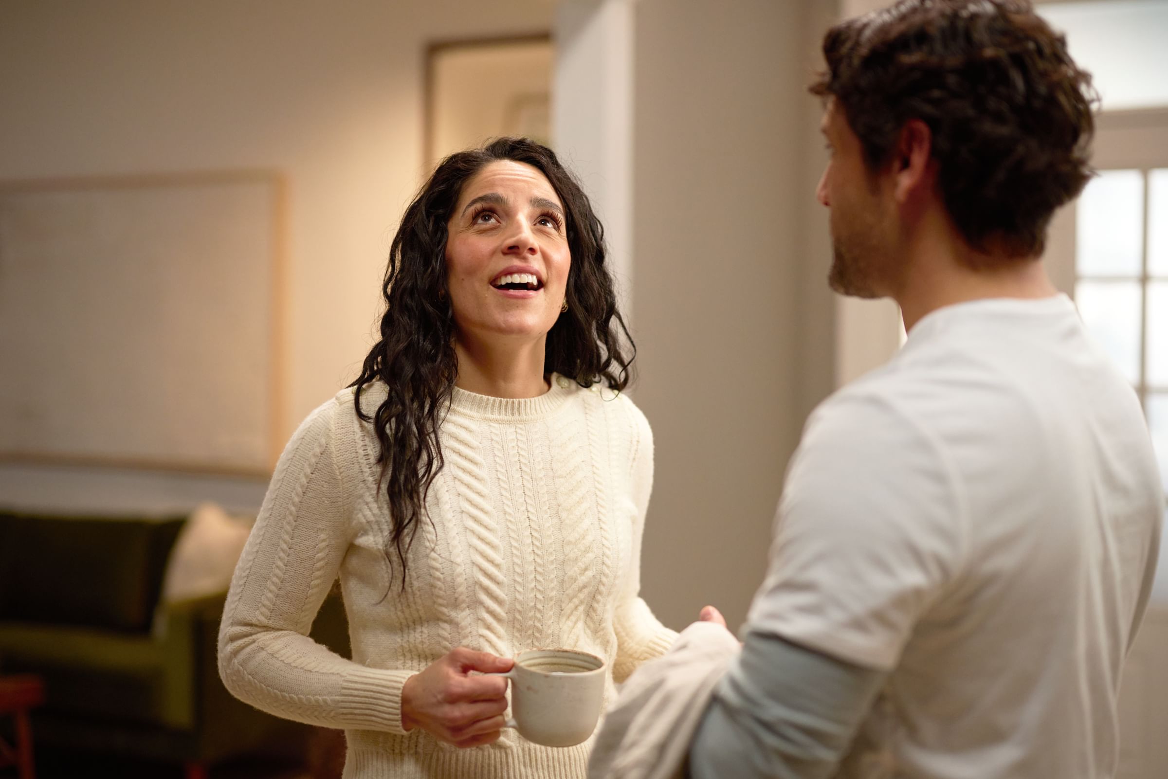 A client talking to a pro painter about her freshly painted walls