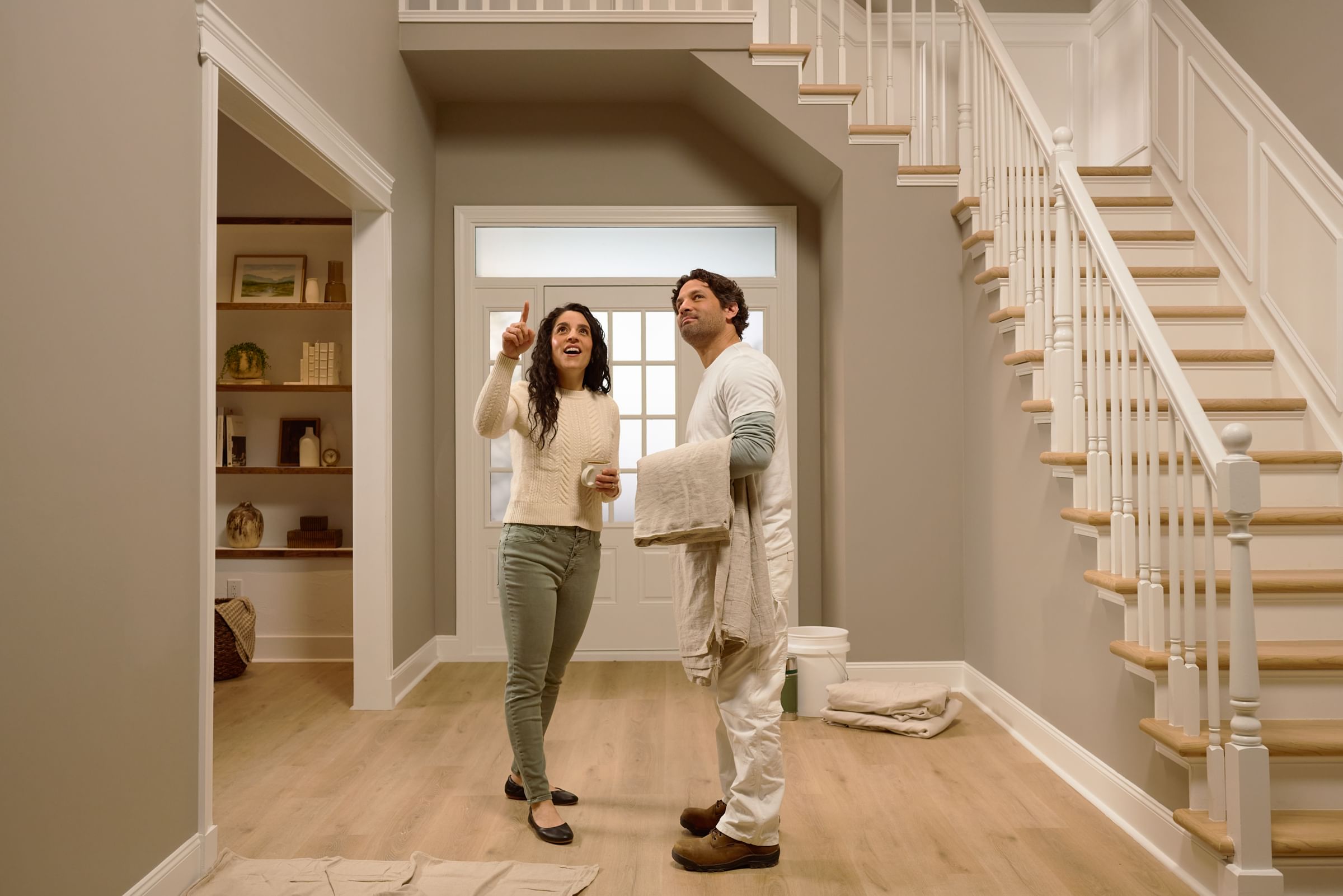 Client talking to Pro Painter in the entryway of her home.