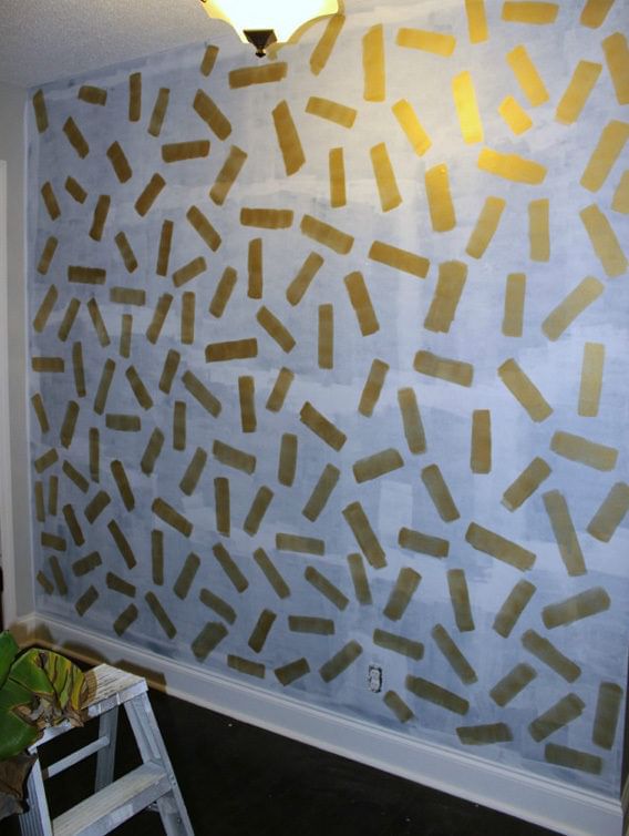 Wall with rectangular splotches of gold painted on it