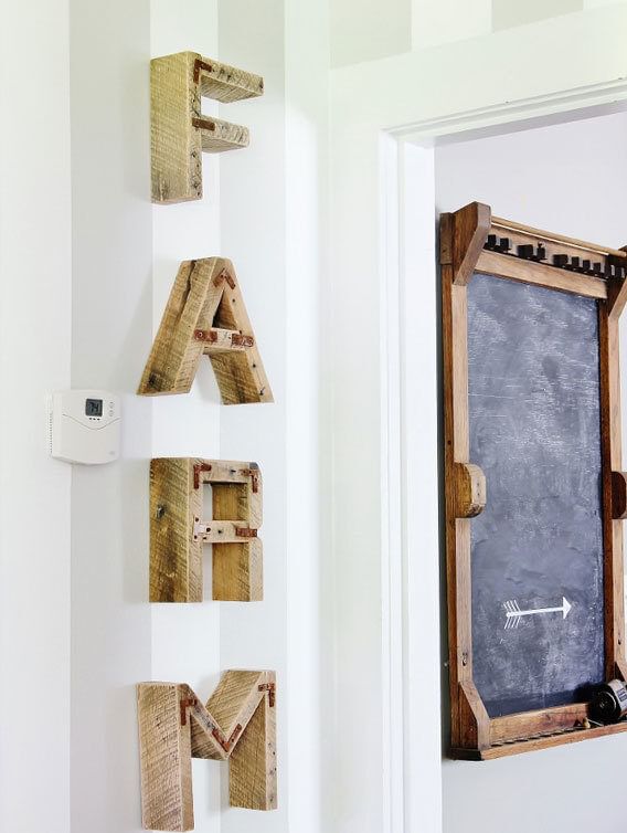 Farm is spelled out in wooden letters descending vertically on a gray and white striped wall