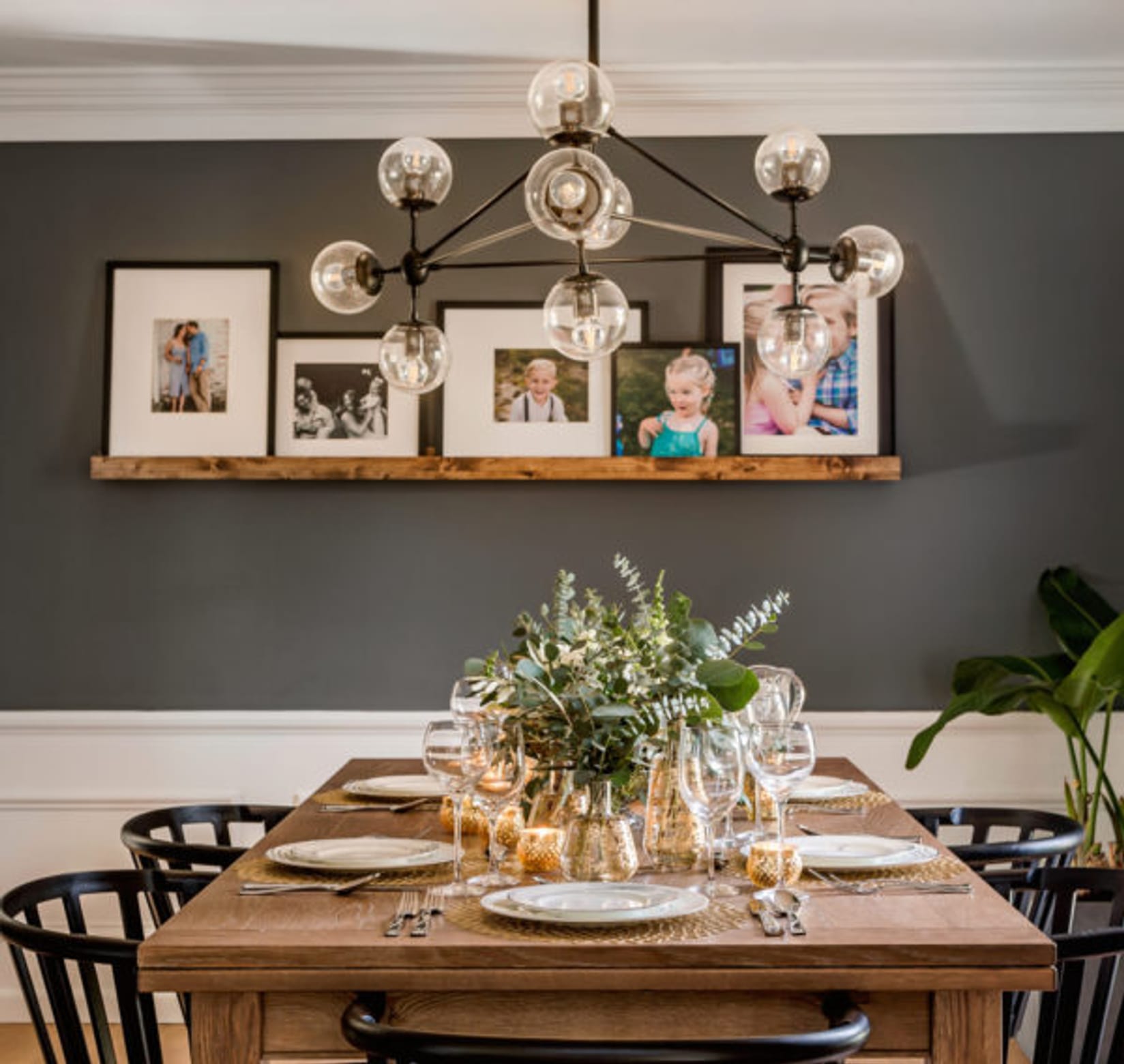 Wooden kitchen table set, with black chairs.