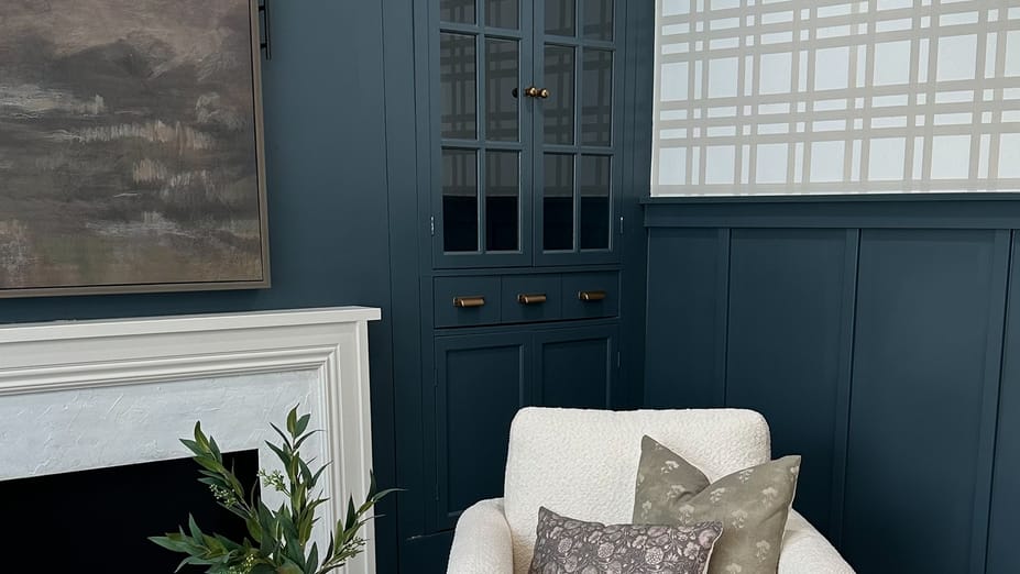 An office space with blue cabinets and wainscotting