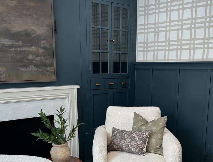 An office space with blue cabinets and wainscotting