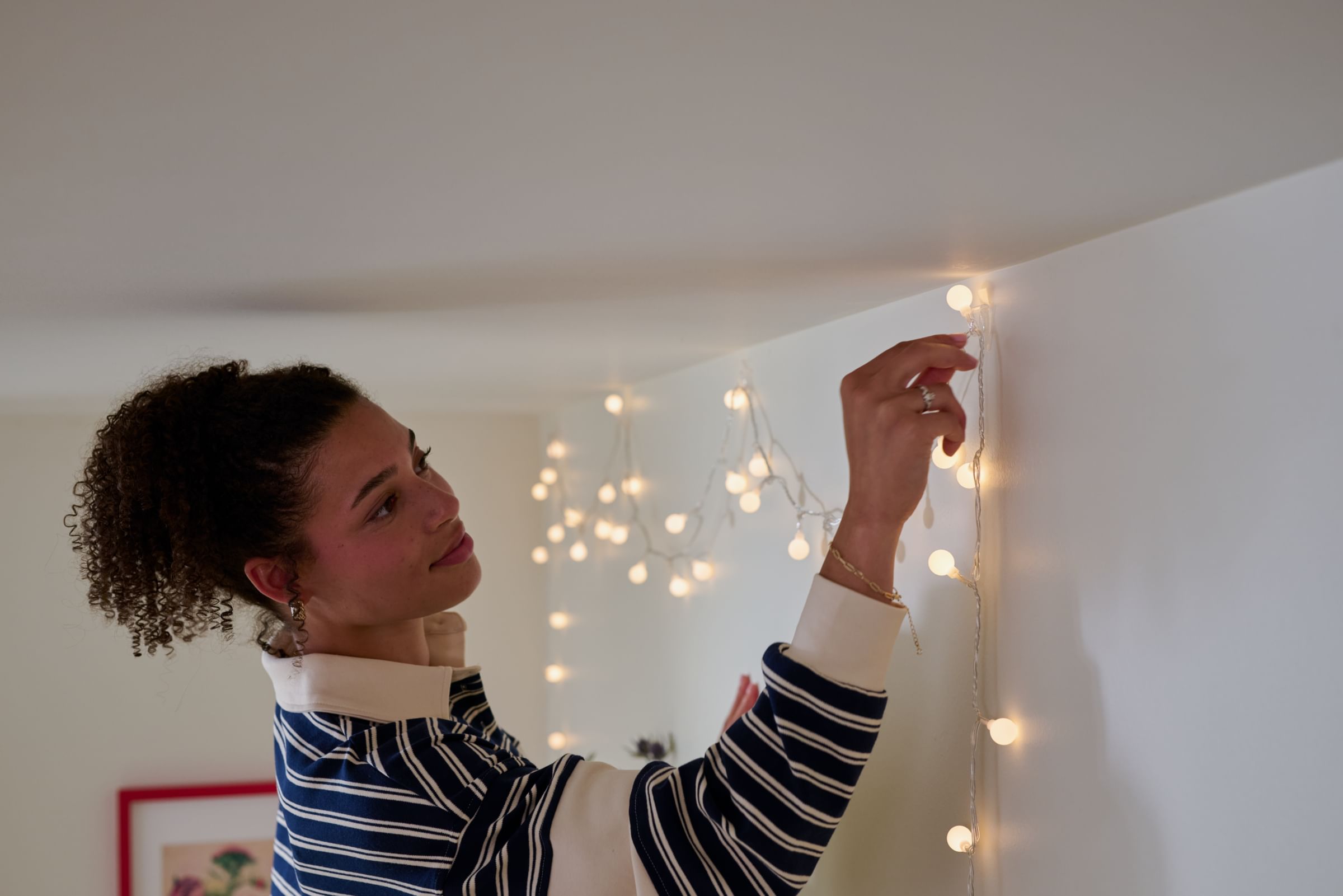 Hanging string lights using FrogTape reMOVEables Heavy-Duty Mini Hooks