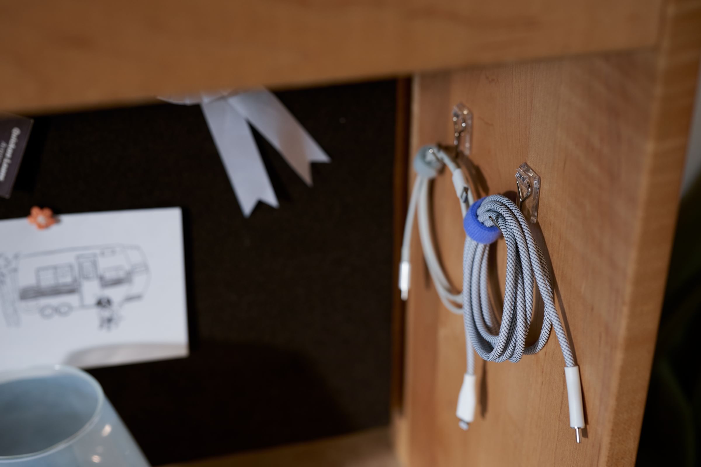 Hanging chargers in a small apartment using FrogTape reMOVEables Wire Hooks and Mini Hooks