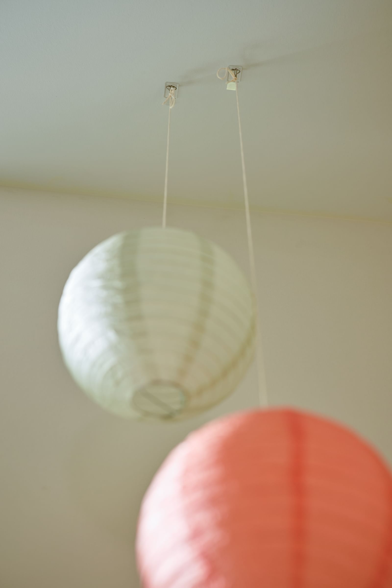 Lanterns in a dorm, hung with FrogTape reMOVEables Clear Wire Hooks