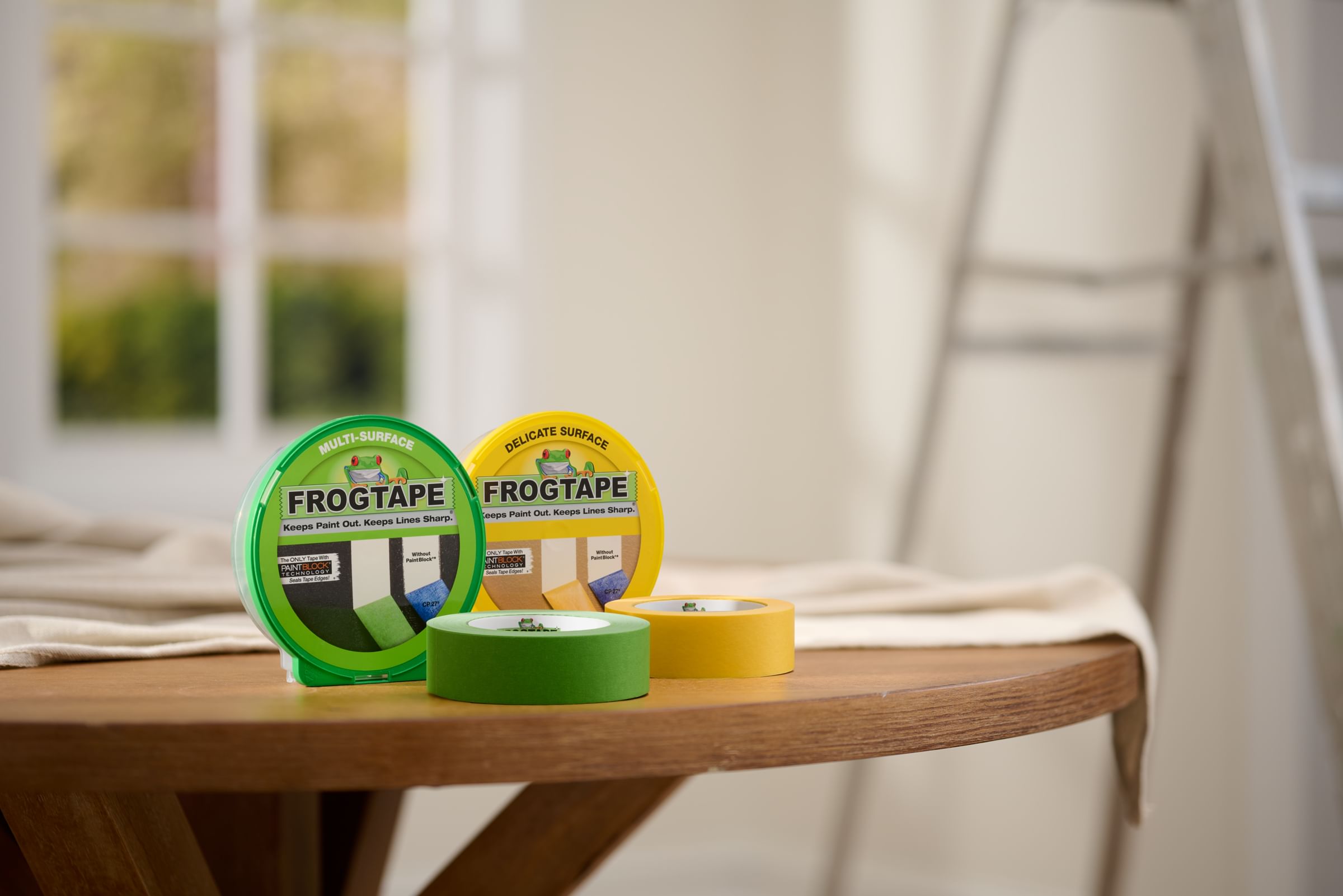 Green FrogTape Multi-Surface Painter's Tape and Yellow FrogTape Delicate Surface Painter's Tape on a table