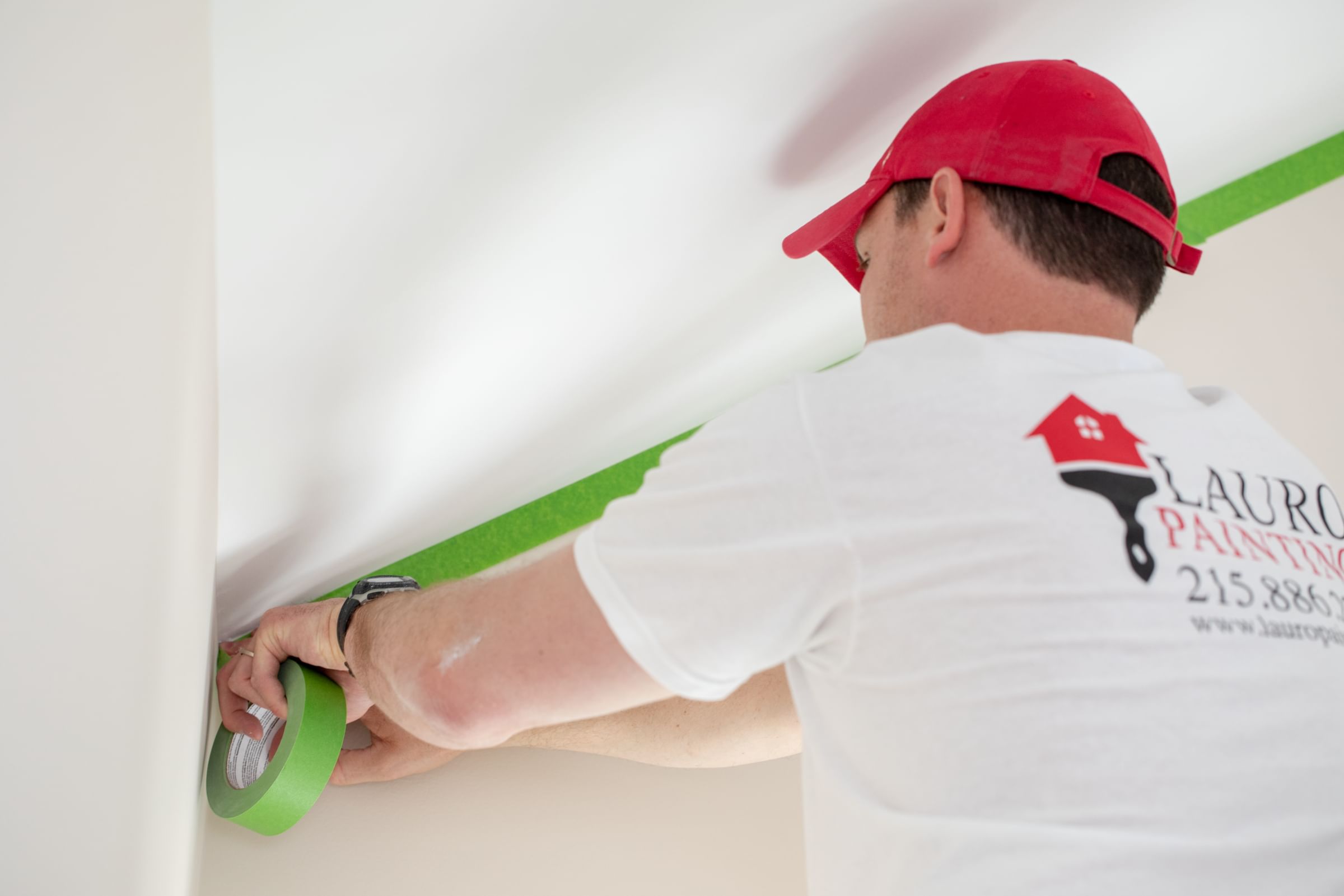 Pro Painter Taming off a section of a wall with Green FrogTape