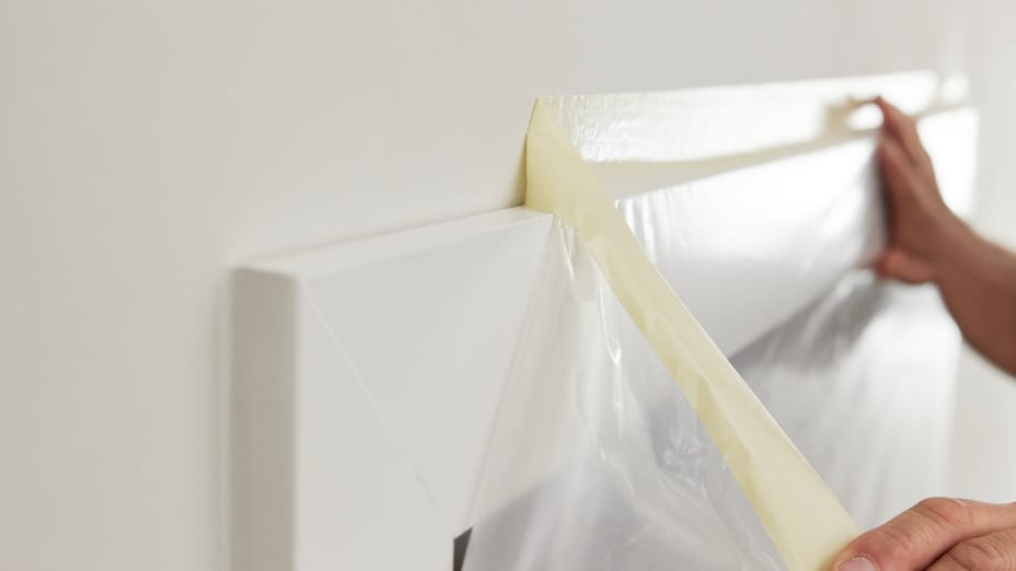 FrogTape Double Sided Poly-Hanging Containment Tape Being Taken down off of the top of a doorway.