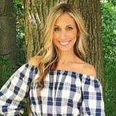 Headshot of a woman in a blue and white plaid top