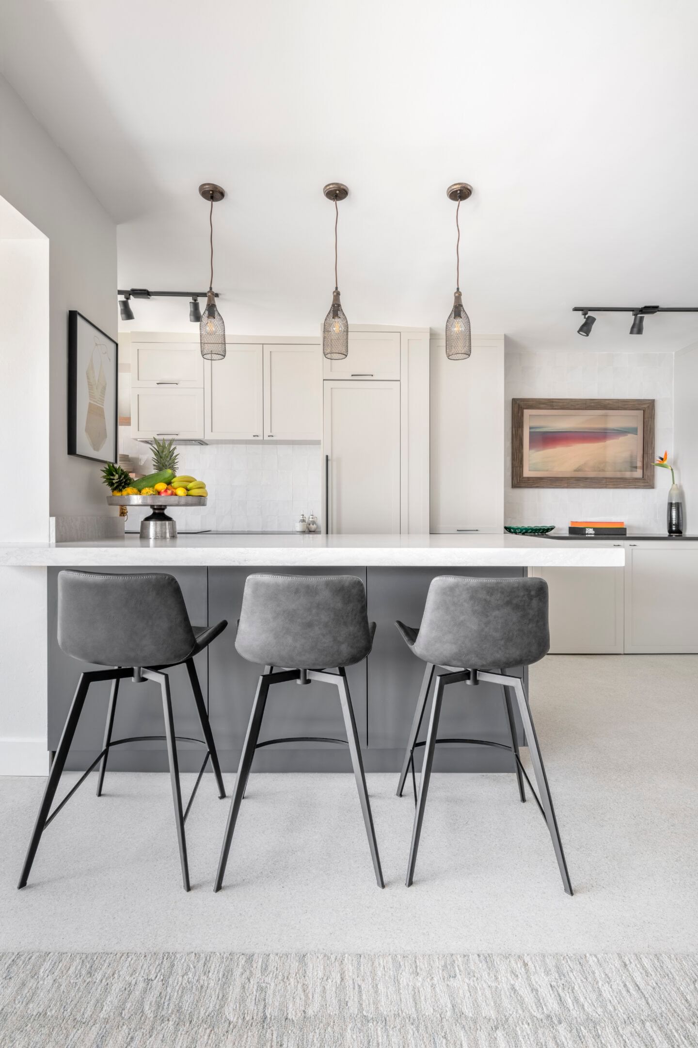 White modern kitchen with gray island and gray stools