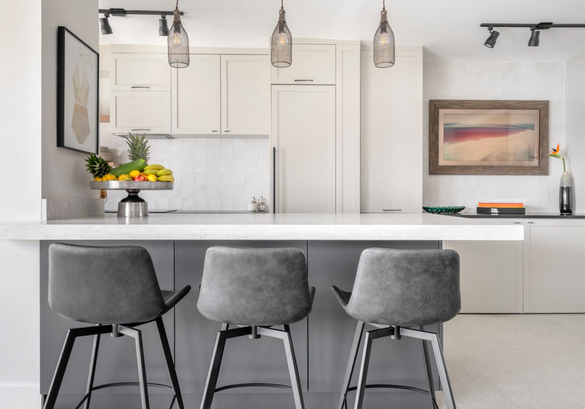 White modern kitchen with gray island and gray stools