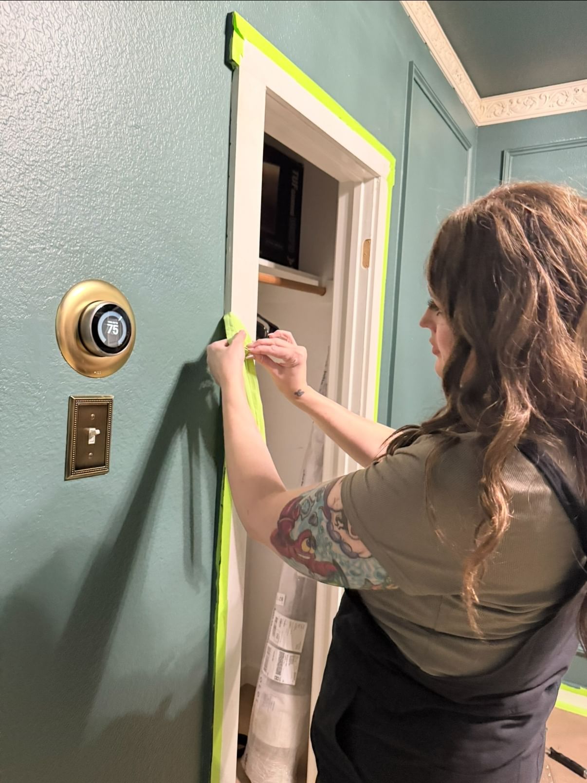 FrogTape Advanced being peeled off of door trim to reveal a crisp paint line.