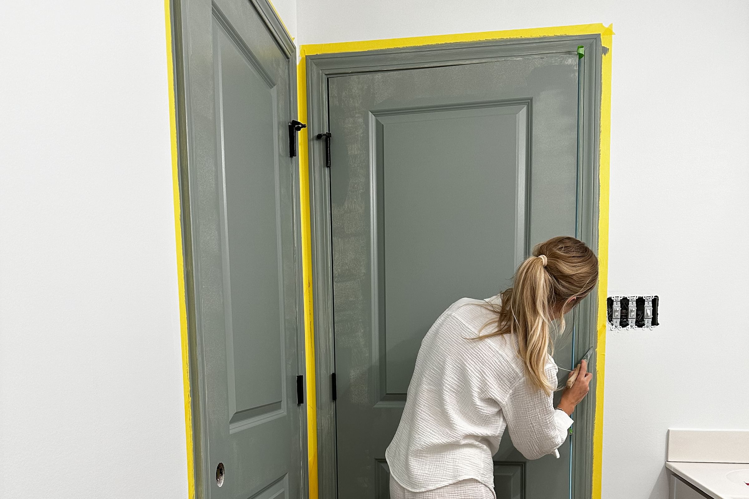 Tori Winkle Painting a door a blue/green color