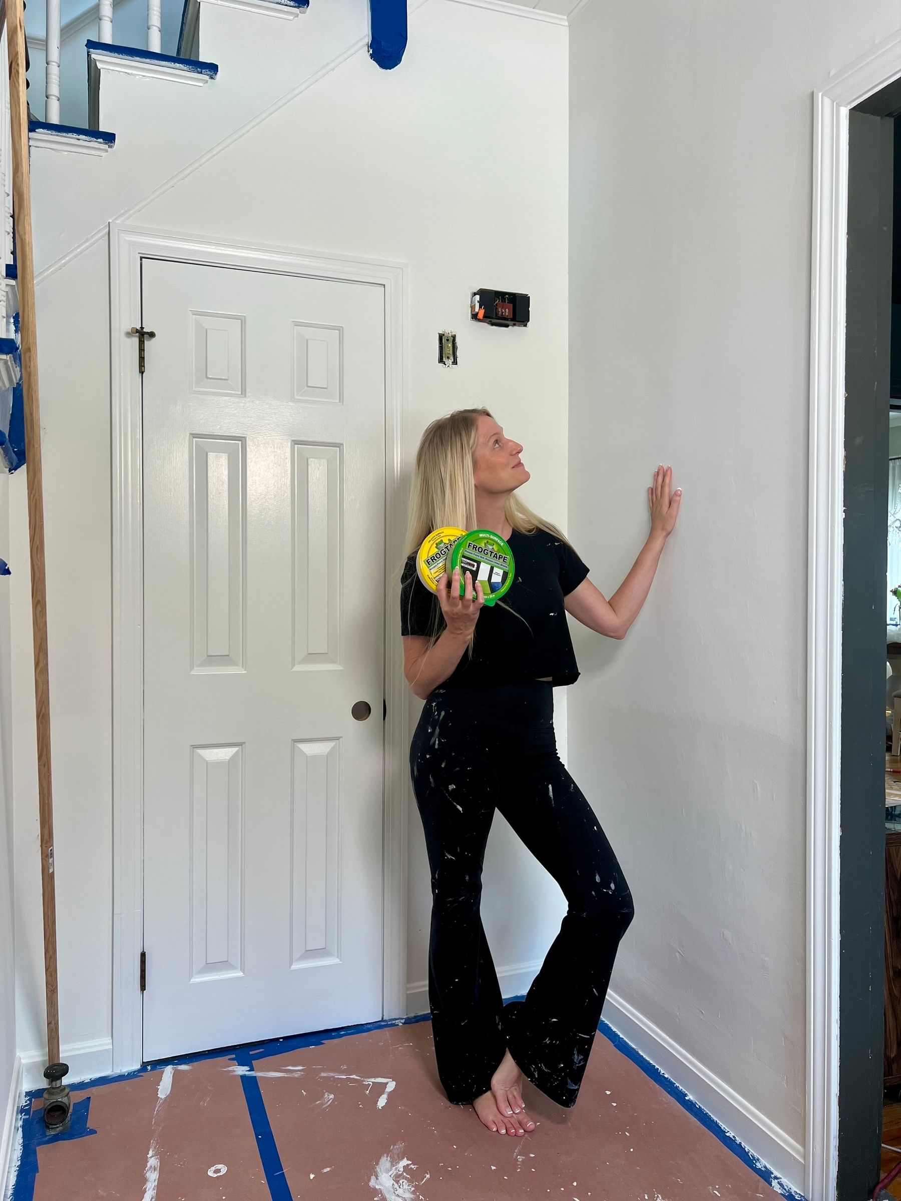 Haley Poole standing in foyer prepping for painting