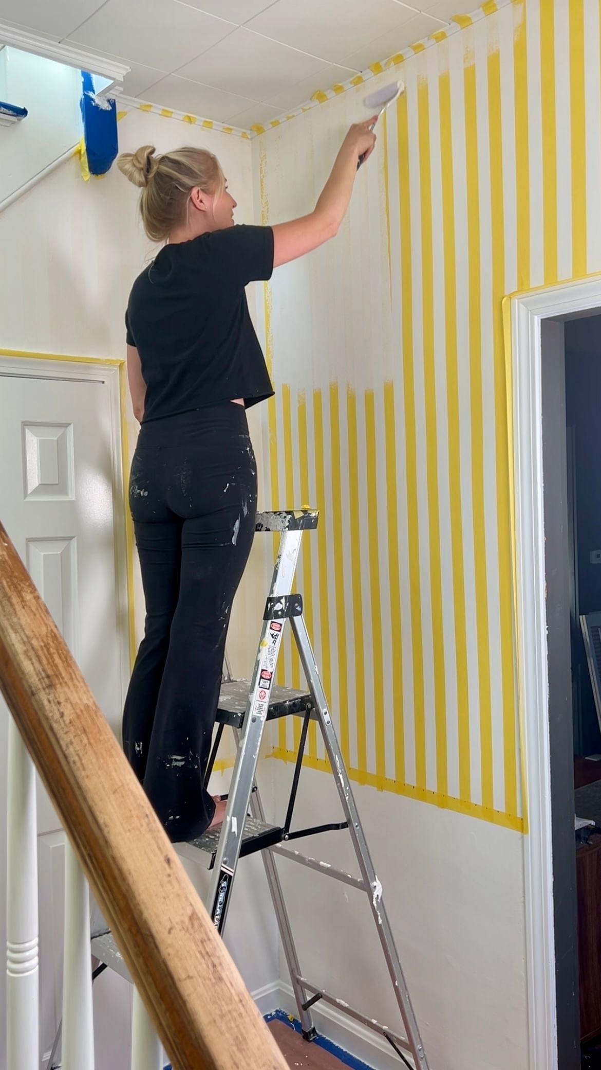 Haley Poole Painting a wall with a roller