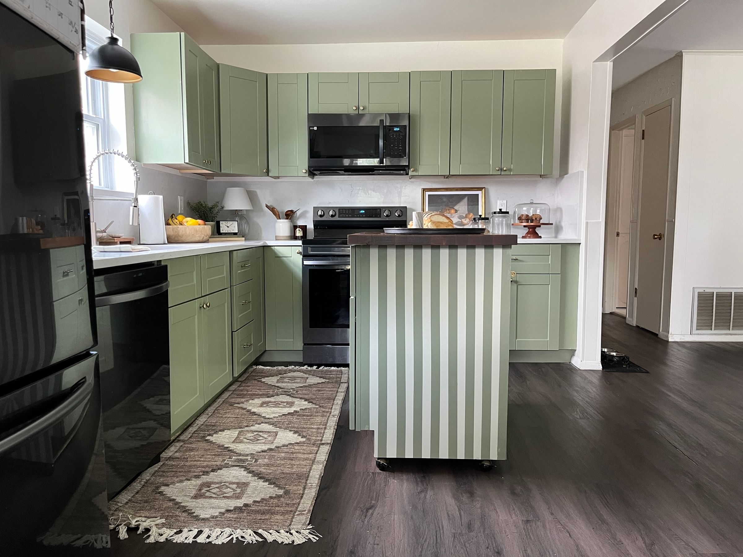 Trendy Kitchen with Green Cabinets and a green and light green striped kitchen island
