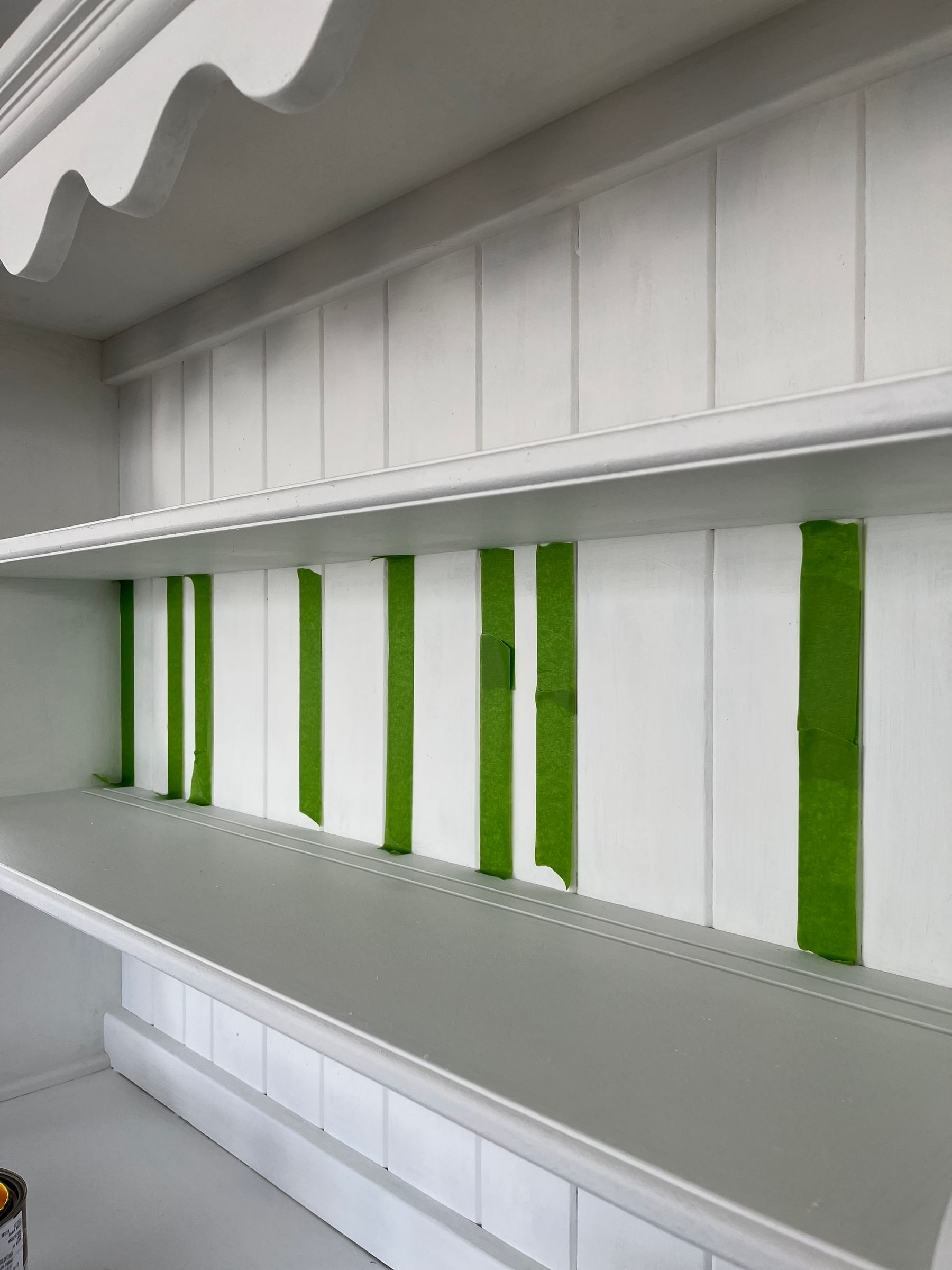 White Hutch with shelves. The back is taped off with strips of green FrogTape Multi-Surface Painter's Tape.