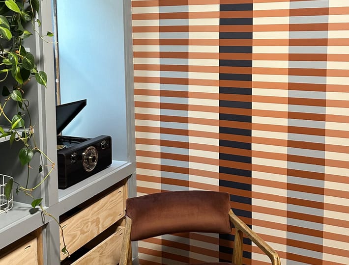 Trendy Room with Striped Line Mural on wall