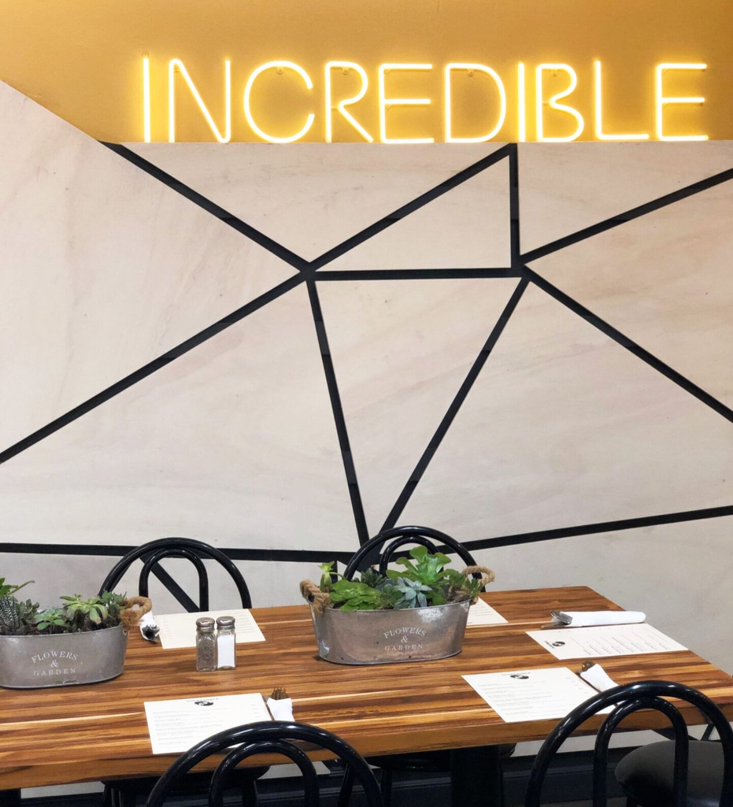 Mural wall in dining room space - white wall with black thin stripes placed in modern geometric pattern