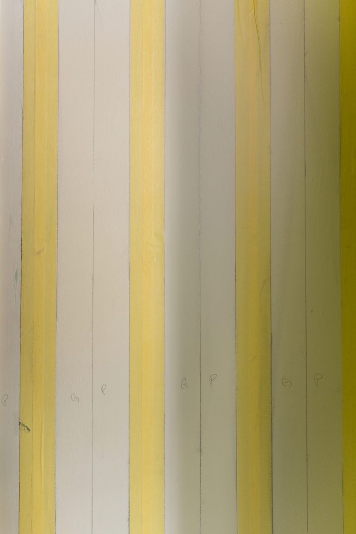 Four Vertical strips of Yellow FrogTape Delicate Surface Painter's Tape spaced out on a wall