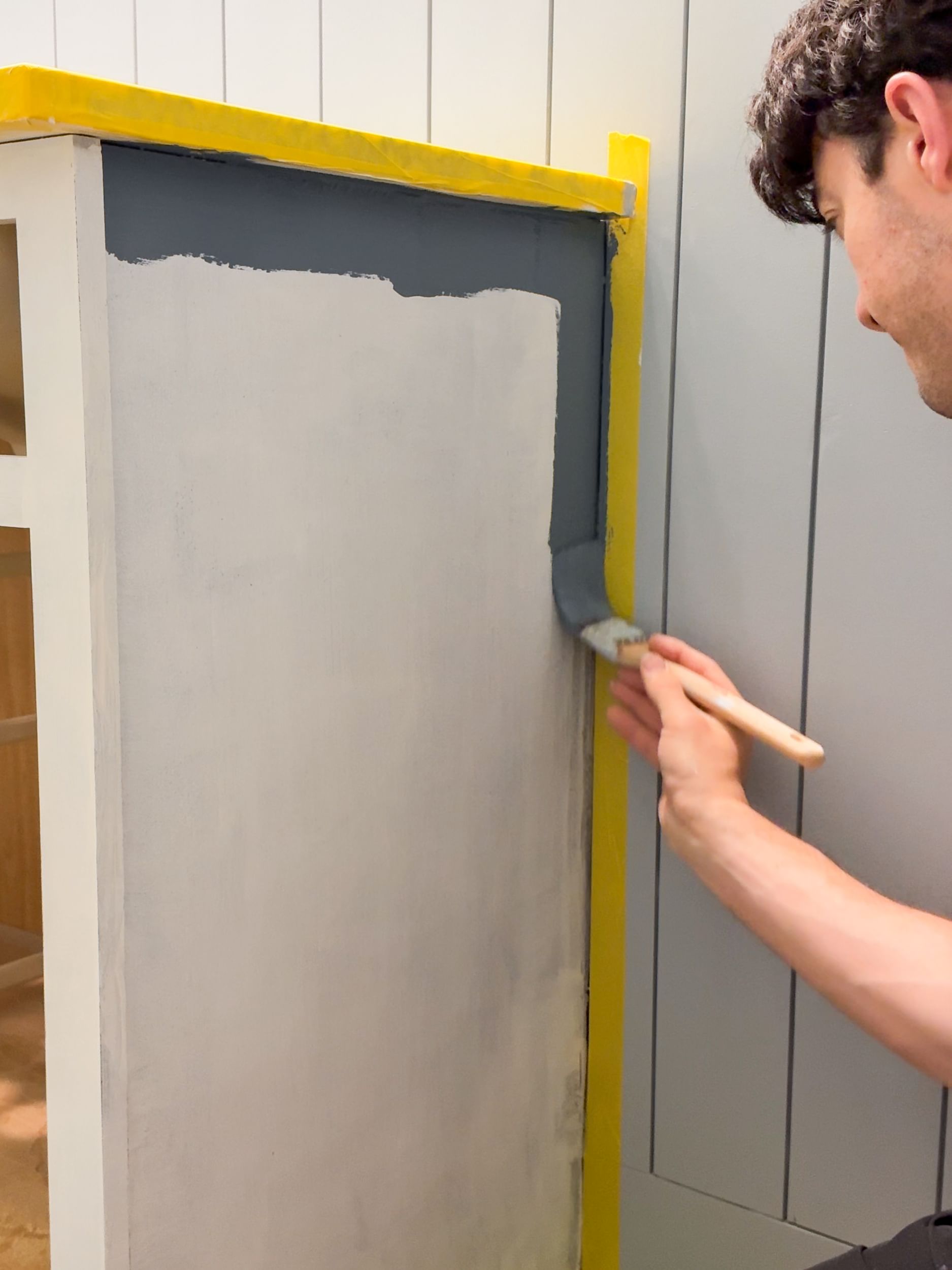 A Bathroom Cabinet being painted a blue gray color
