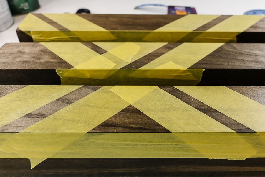 Yellow FrogTape Delicate Surface Painter's Tape taped across wooden shelves.