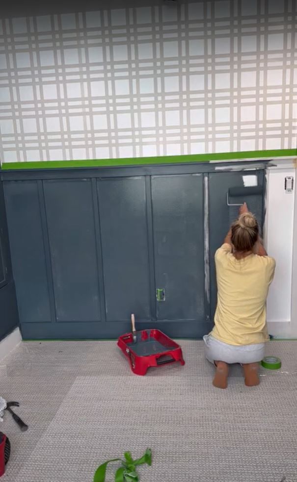 Sarah Merrell Painting the Wainscotting blue with a roller