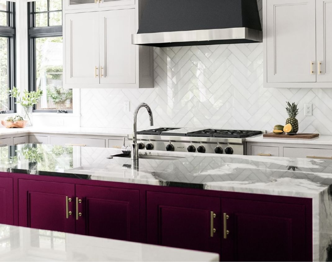 Modern White Kitchen with vibrant purple kitchen island cabinets.