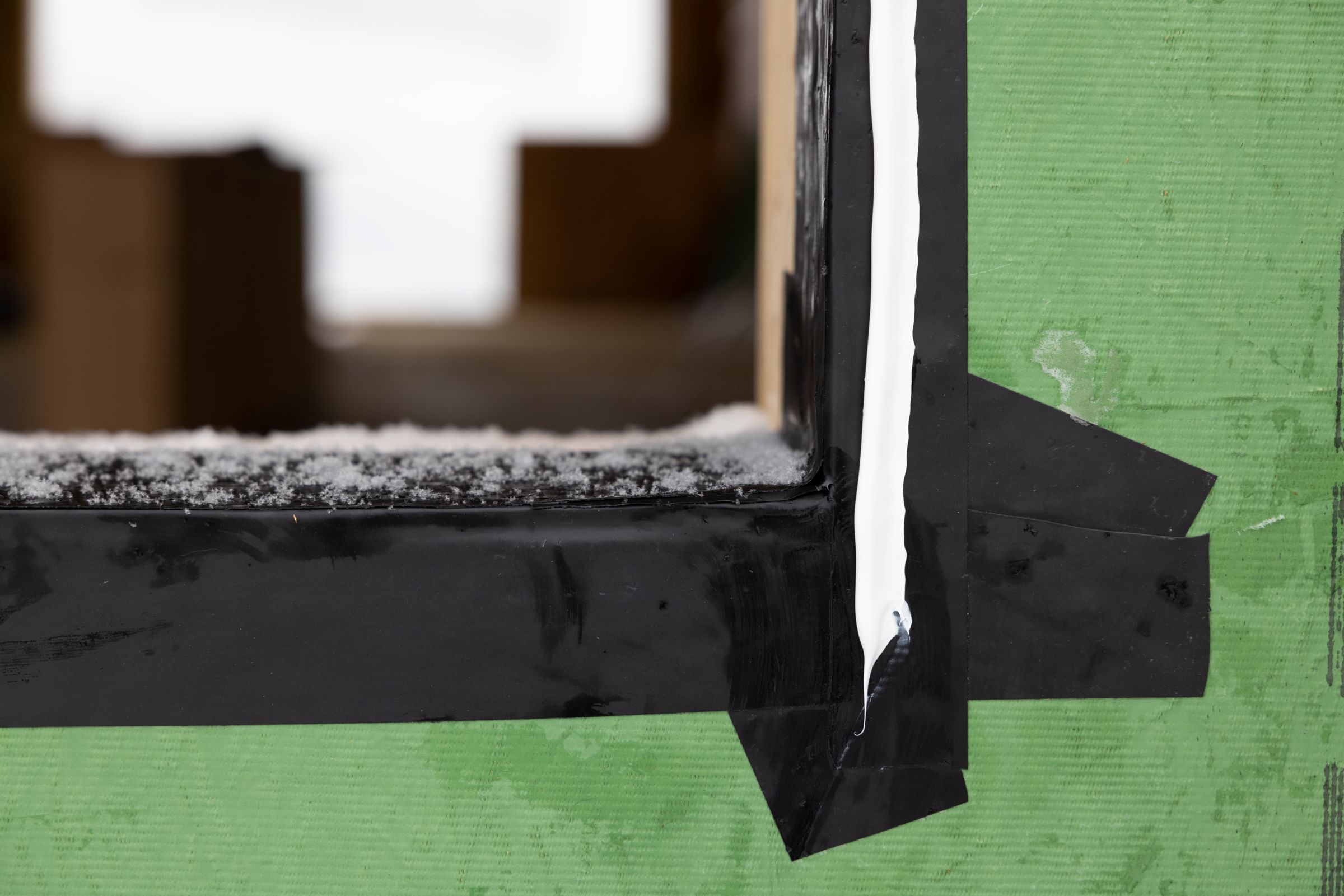 FrogTape Flashing Tape covering the seams of an icy window hole