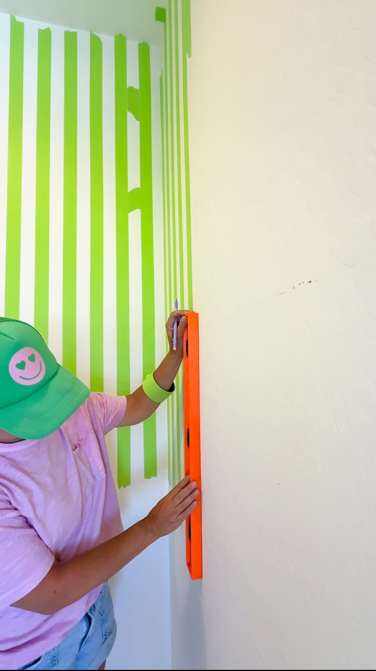 Woman measuring out tape edges with a level