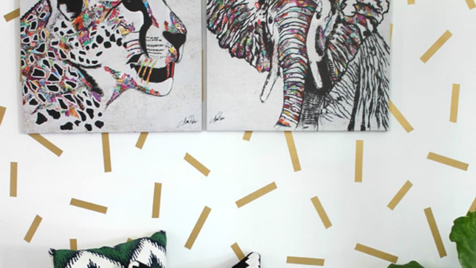 Lepard and Elefant Paintings hung on a white wall with gold confetti