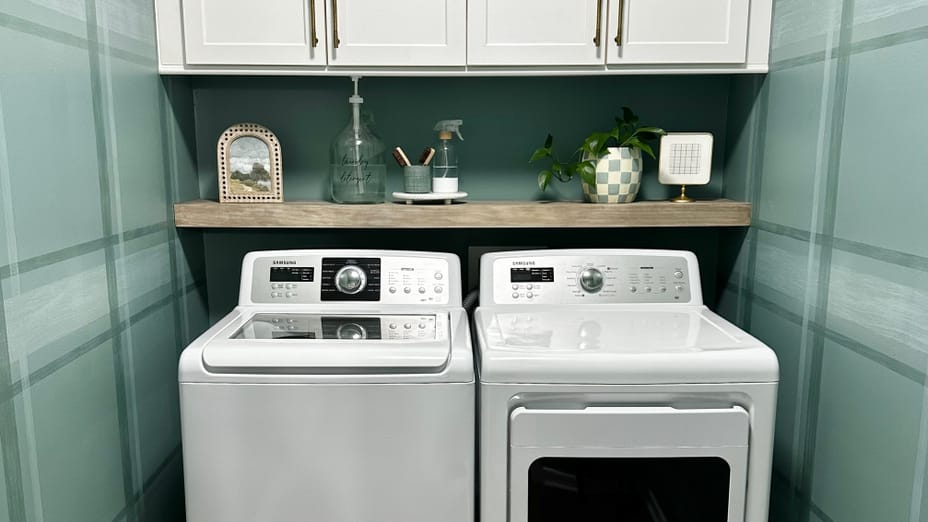 Modern Laundry Room with Washer, Dryer, shelf above, and upper cabinets. The walls are blue/green with a plaid pattern