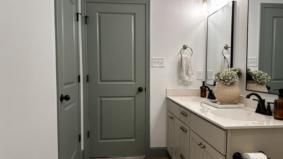 Neutral Bathroom with Blue/green doors that add a pop of color to the room