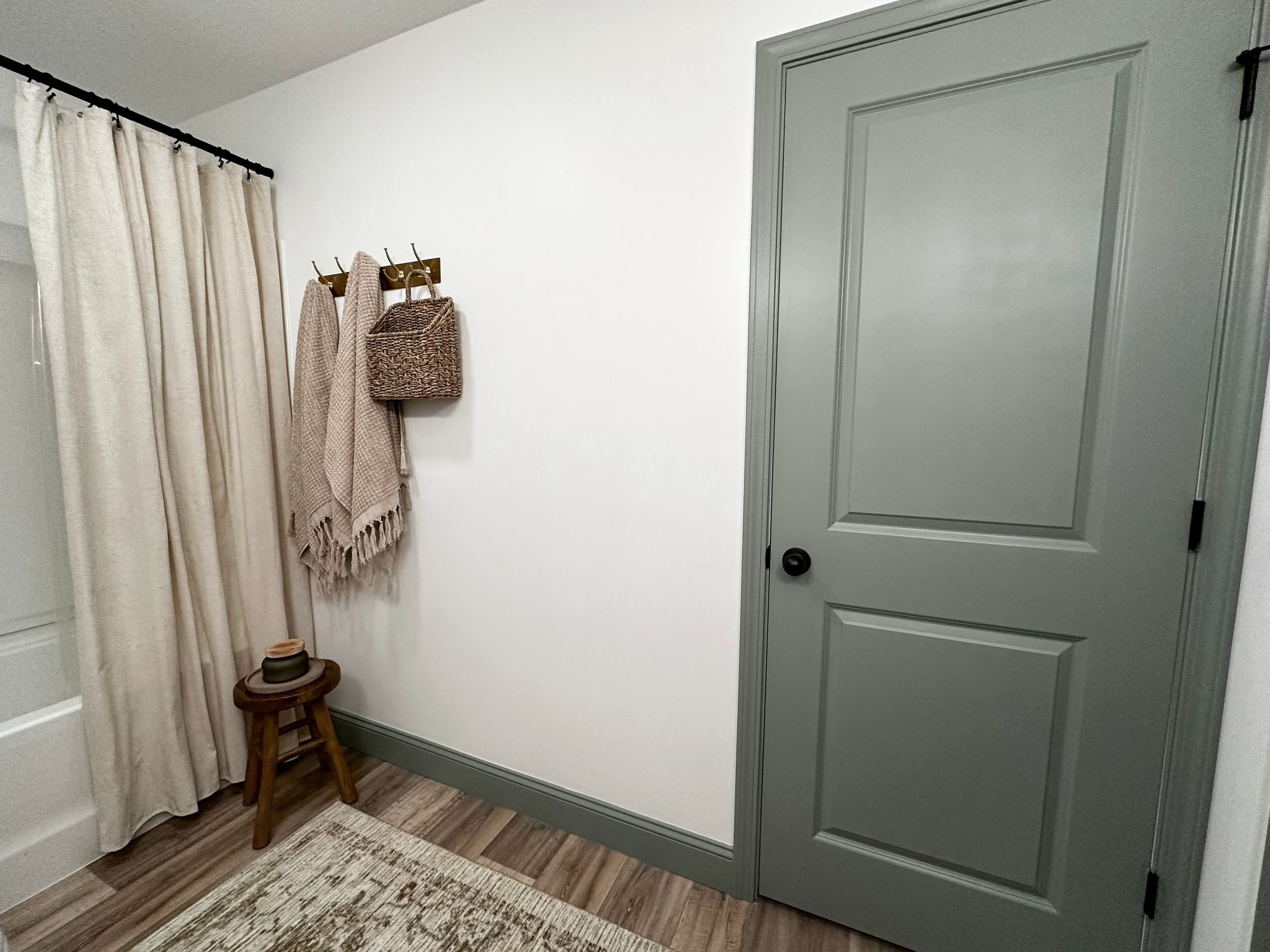 Freshly painted blue/green door and trim in a bathroom