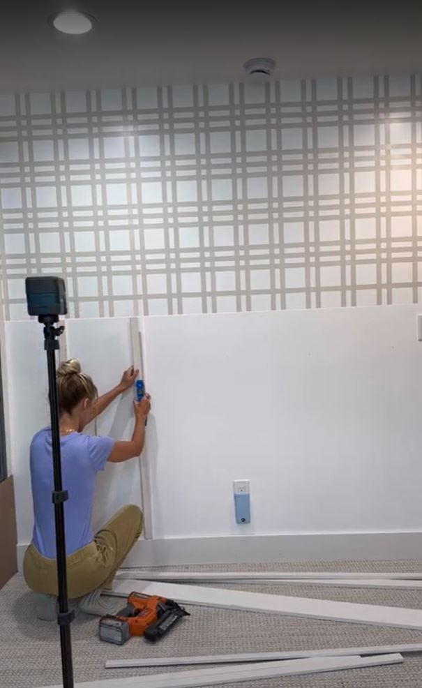 Sarah Merrel Marking where the boards for the wainscotting will go on the wall