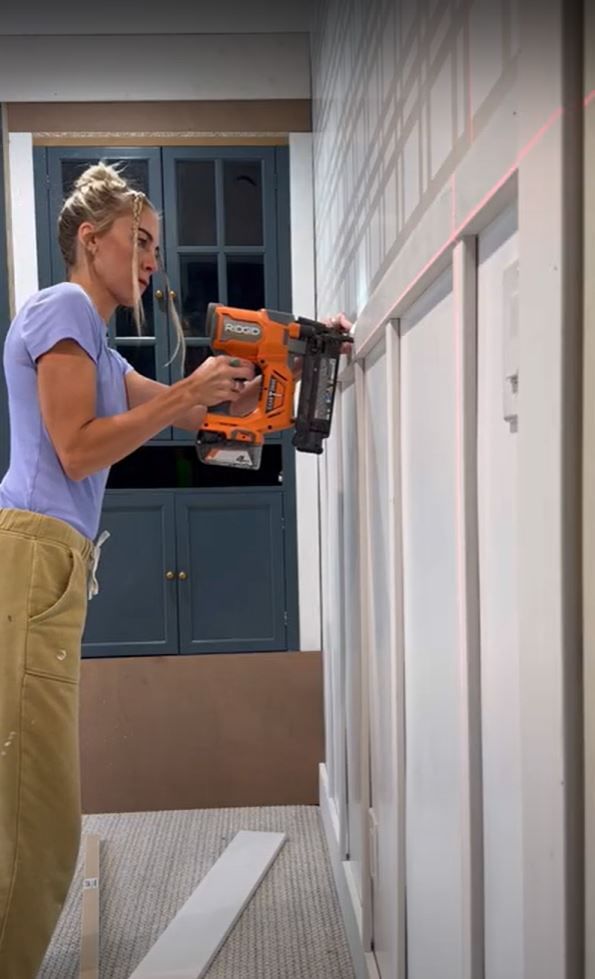Sarah Merrell Nailing Boards to the wall to create wainscotting