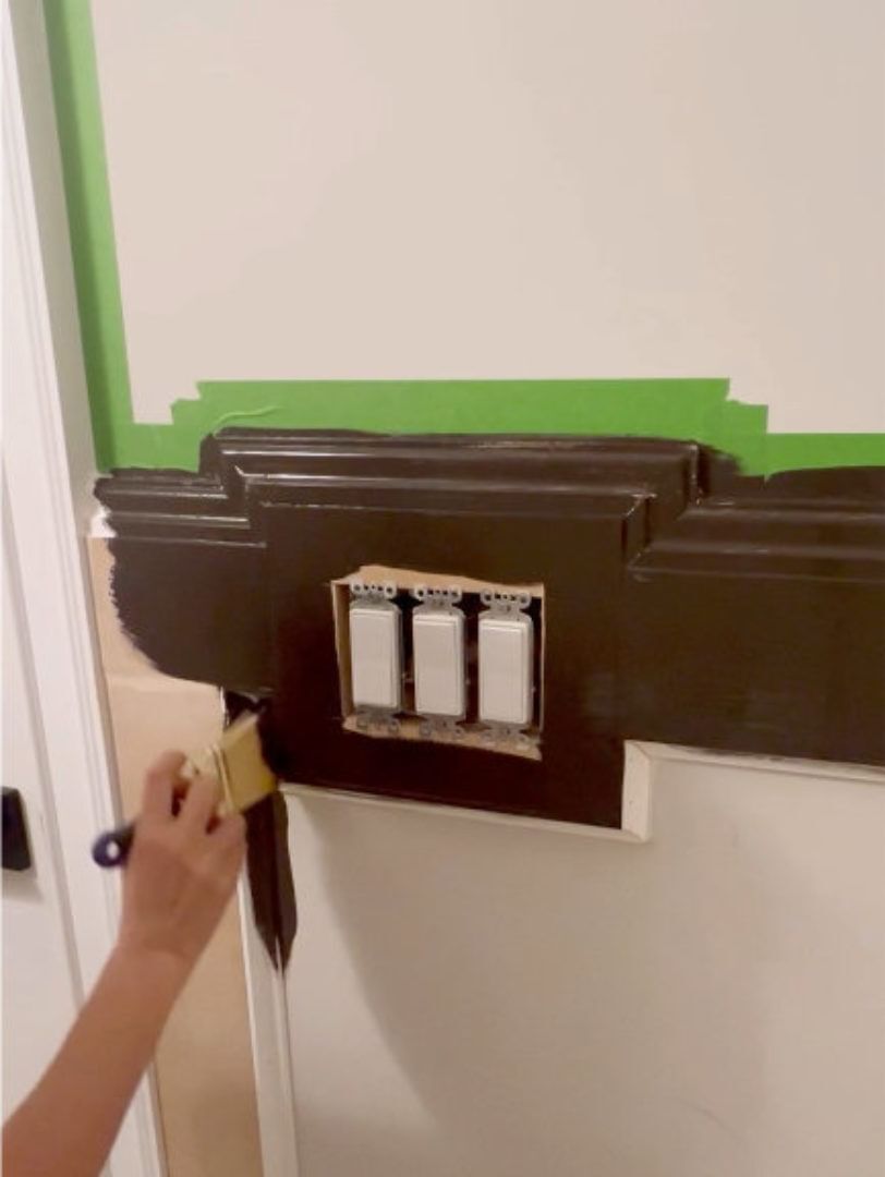 hand brushing around the light switch