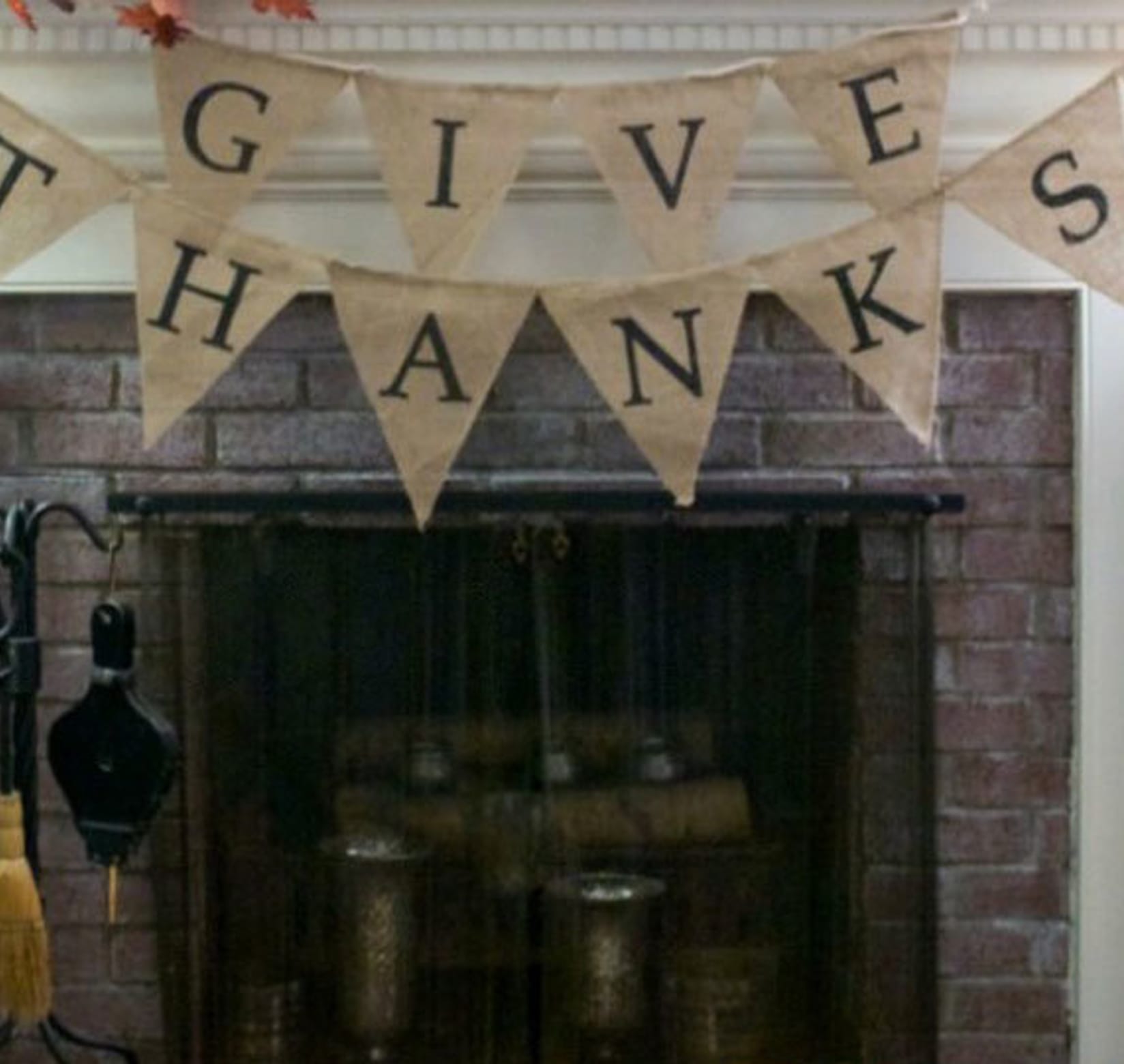 Whitewashed brick fireplace with a banner above that says Give Thanks